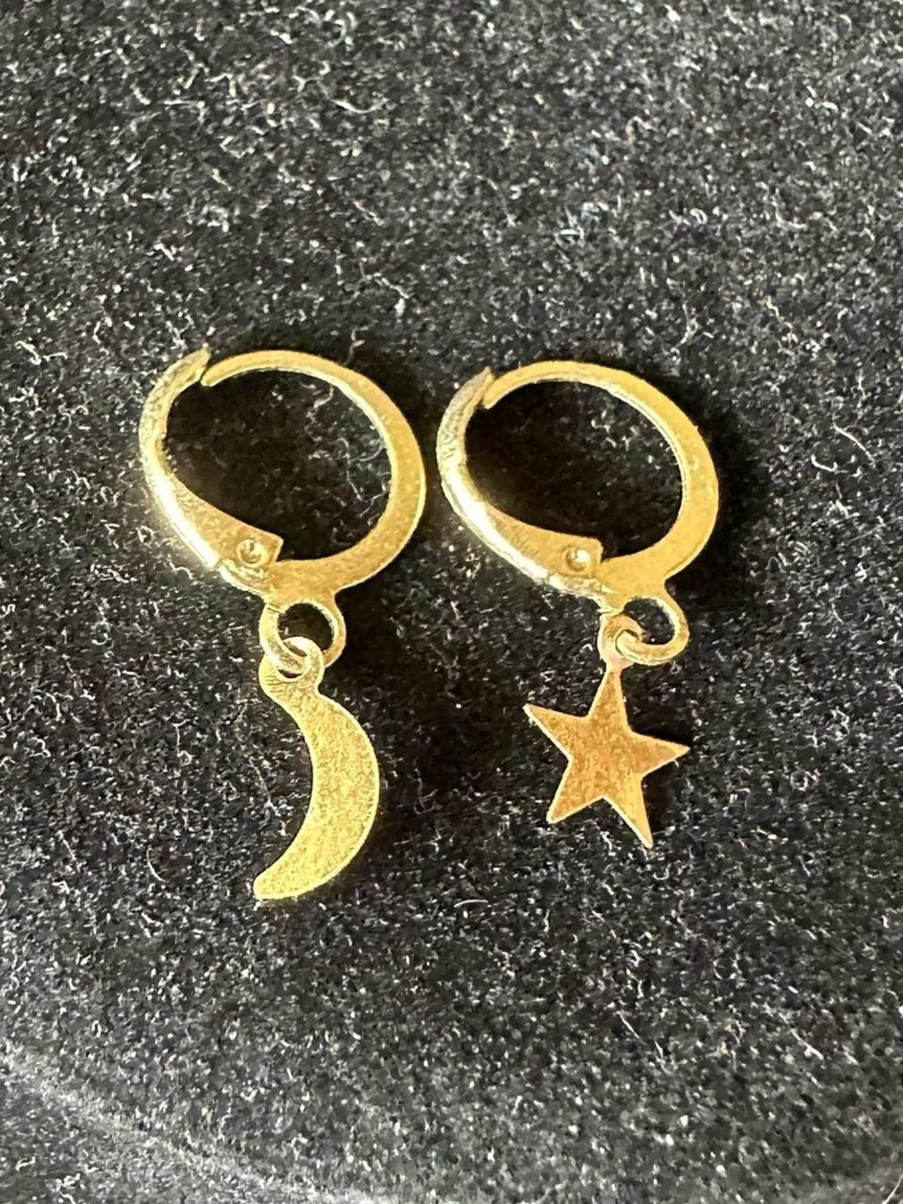 Vintage golden dangly mismatched moon and star earrings.